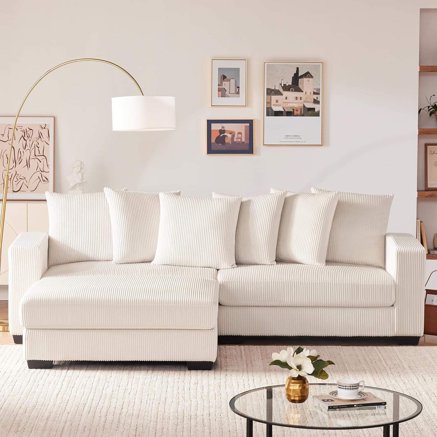 Beige sectional sofa in a living room with decor elements.