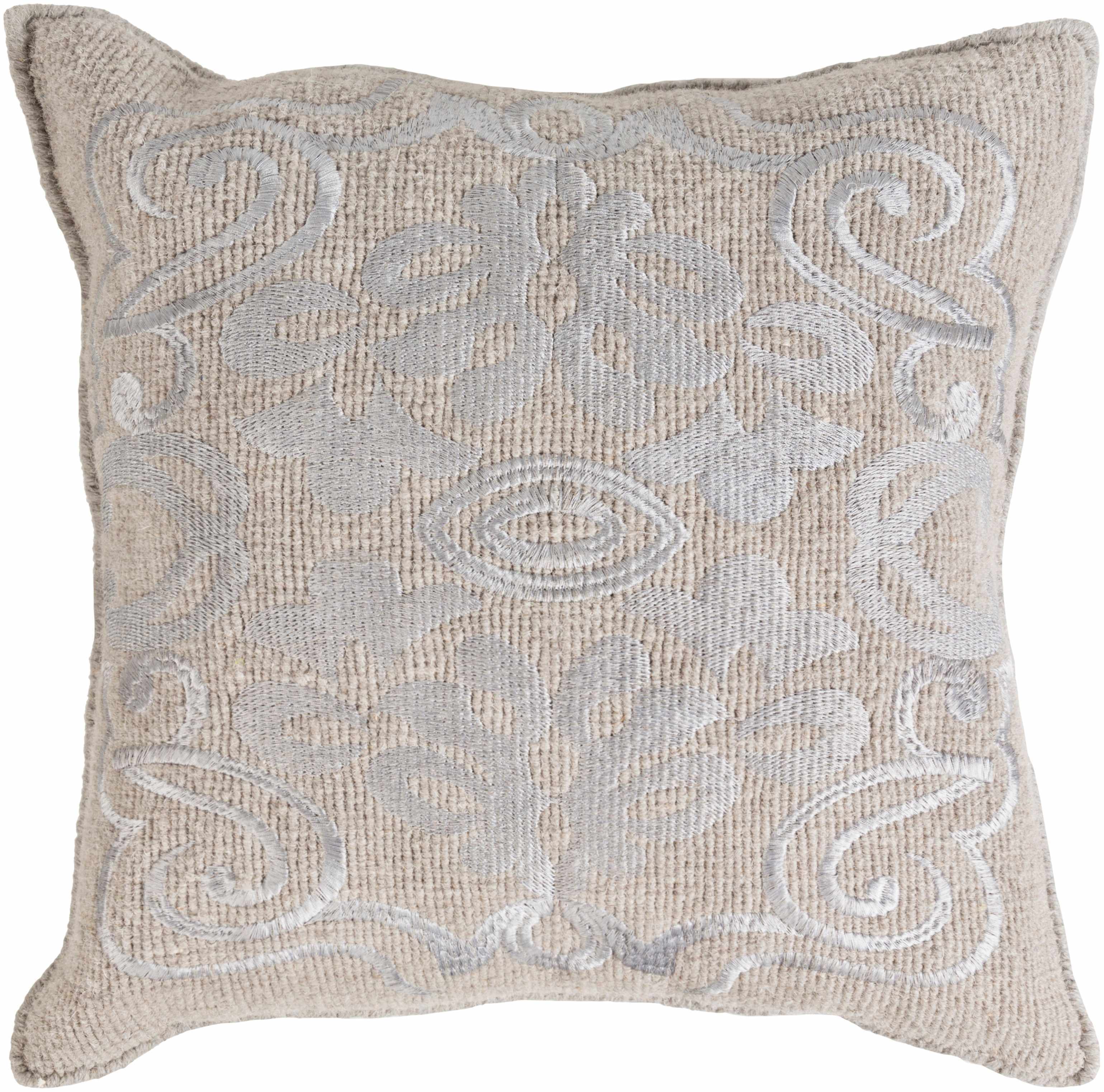 Decorative pillow with intricate patterns on a beige background