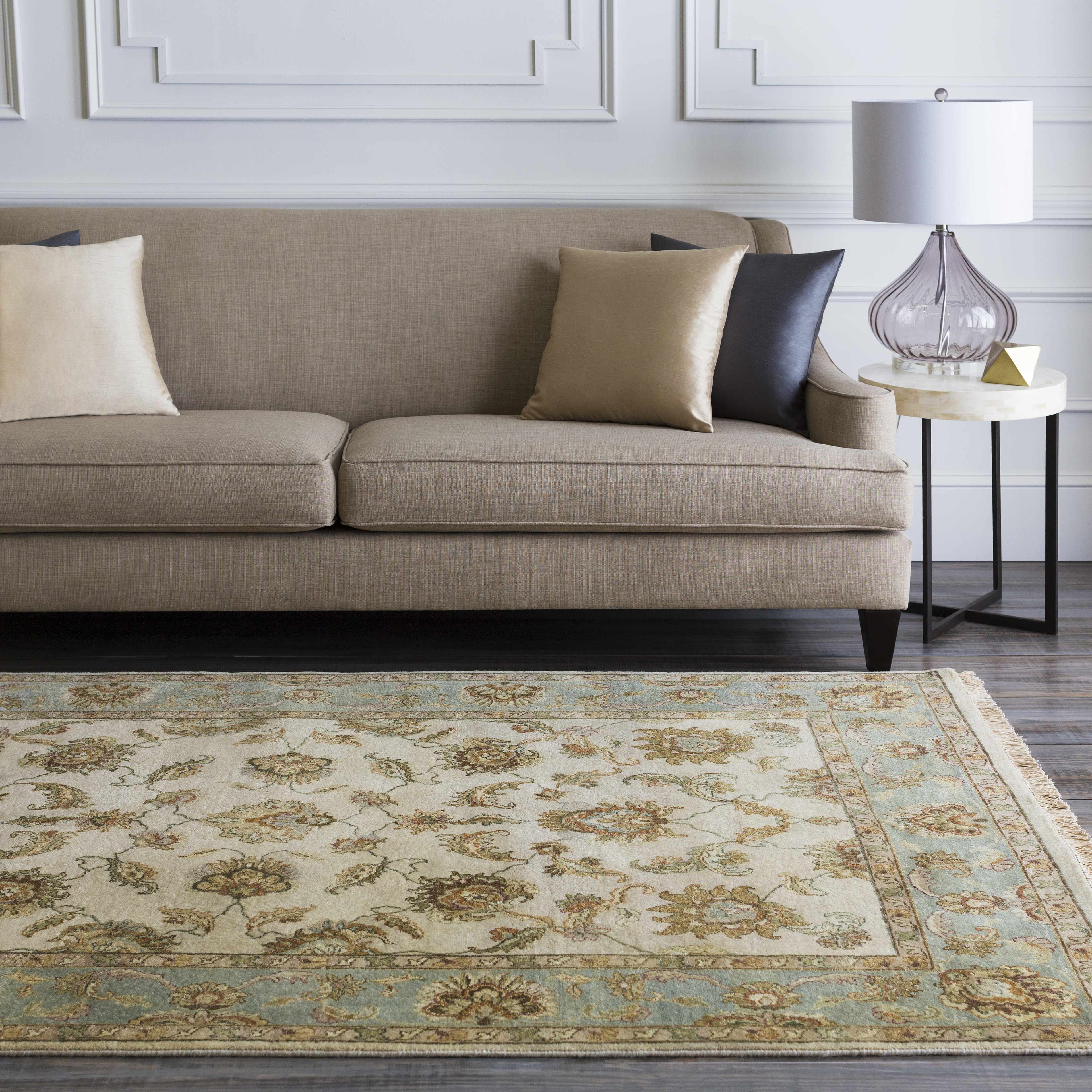 Living room with a beige sofa and patterned rug