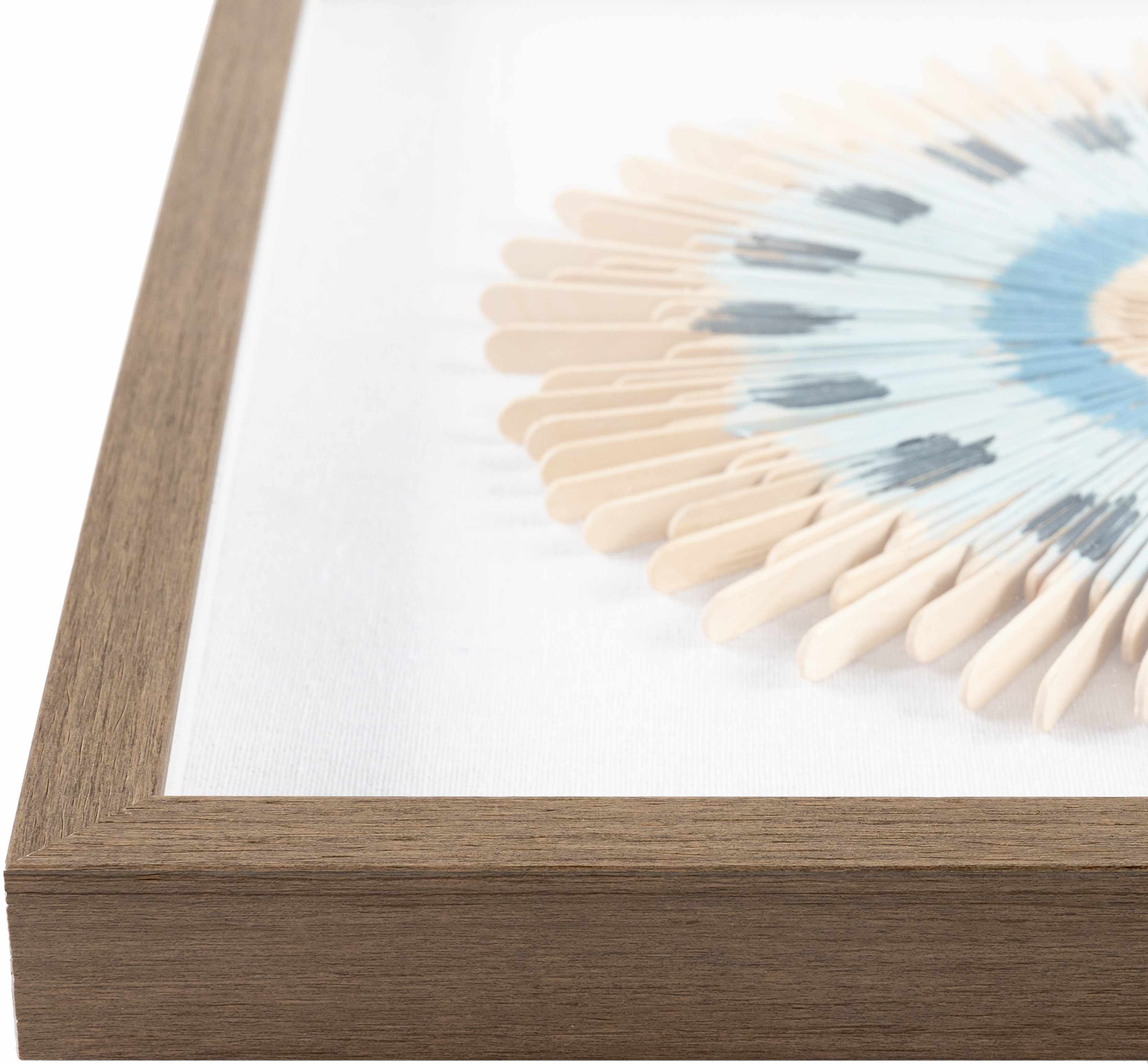 Framed artwork with wooden frame and white mat displaying a circular design with colors.