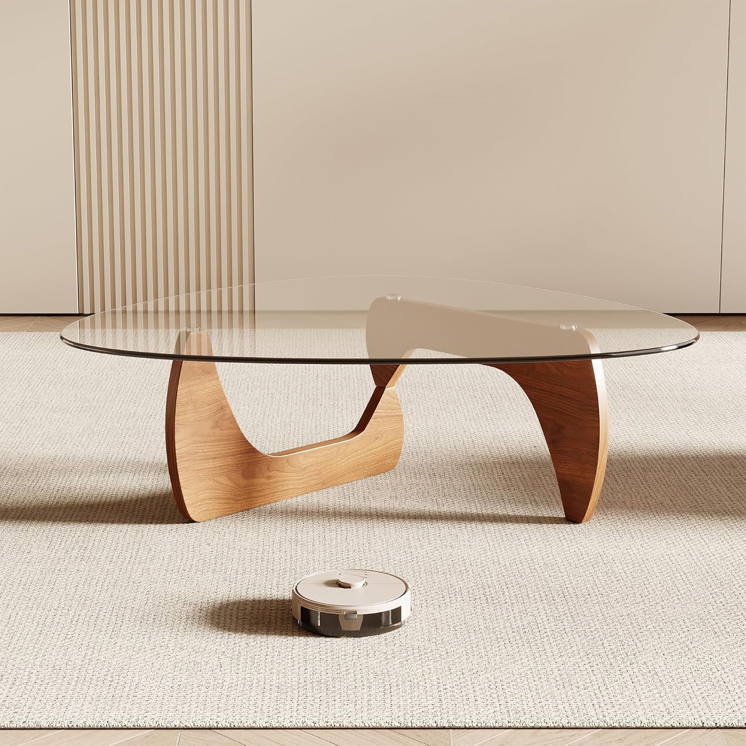 Modern coffee table with glass top and wooden legs on a neutral background