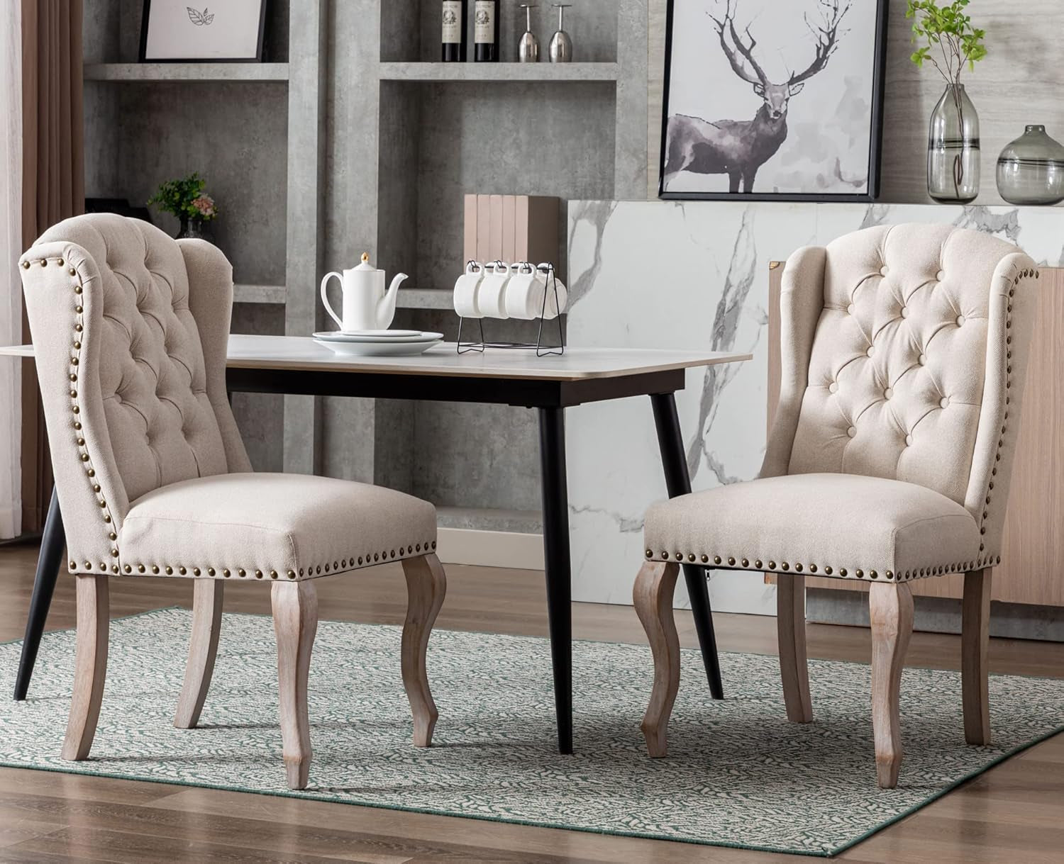 Dining room with two upholstered chairs and a table, featuring a neutral color scheme.