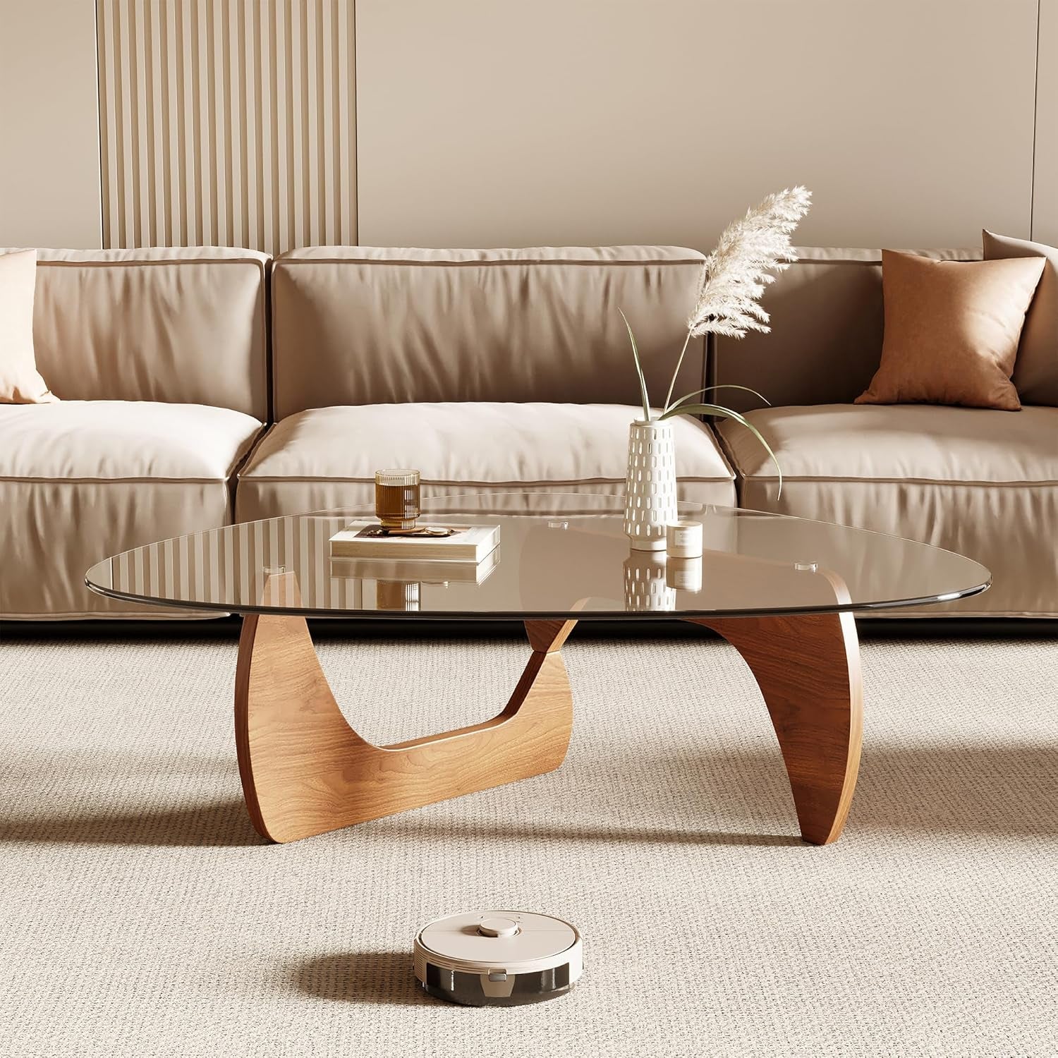 Modern living room with a glass coffee table and beige sofa.
