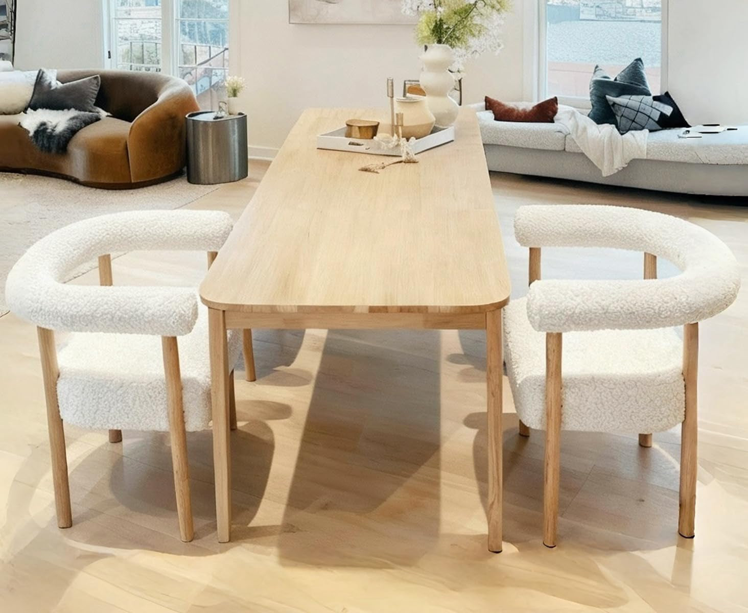 Dining area with a wooden table and chairs in a modern living room.
