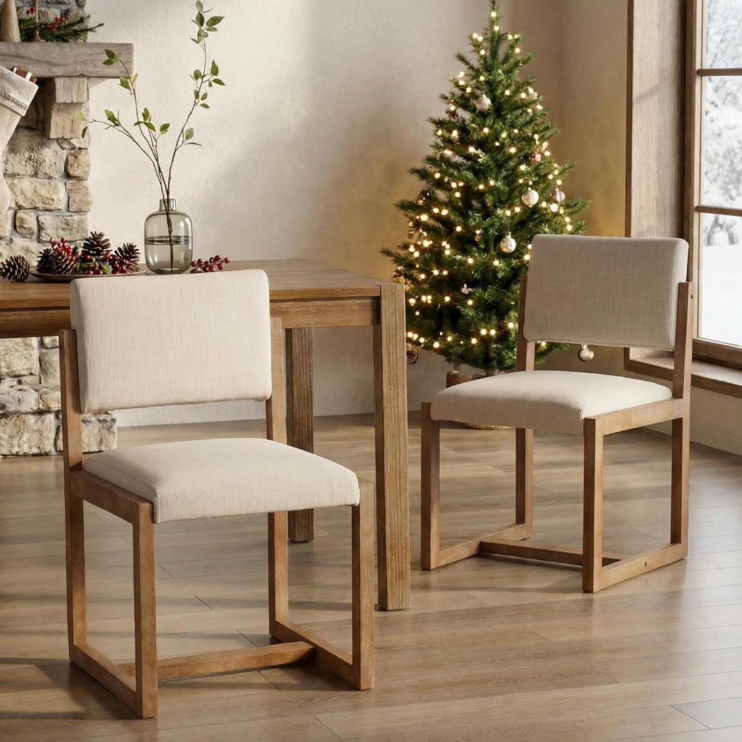  wooden chairs and white cushions in a bright room.
