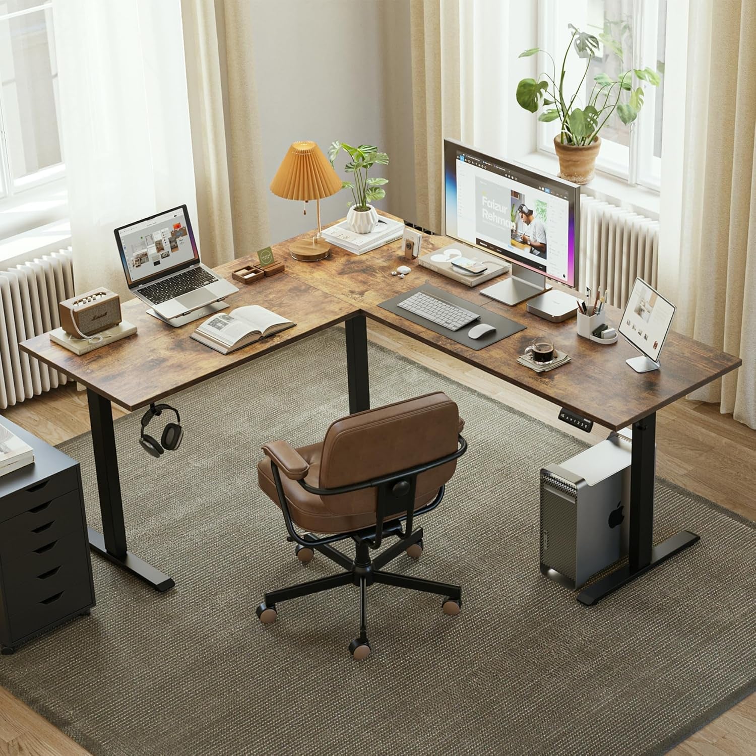 Modern home office with a L-shaped wooden desk, chair, and computer setup.