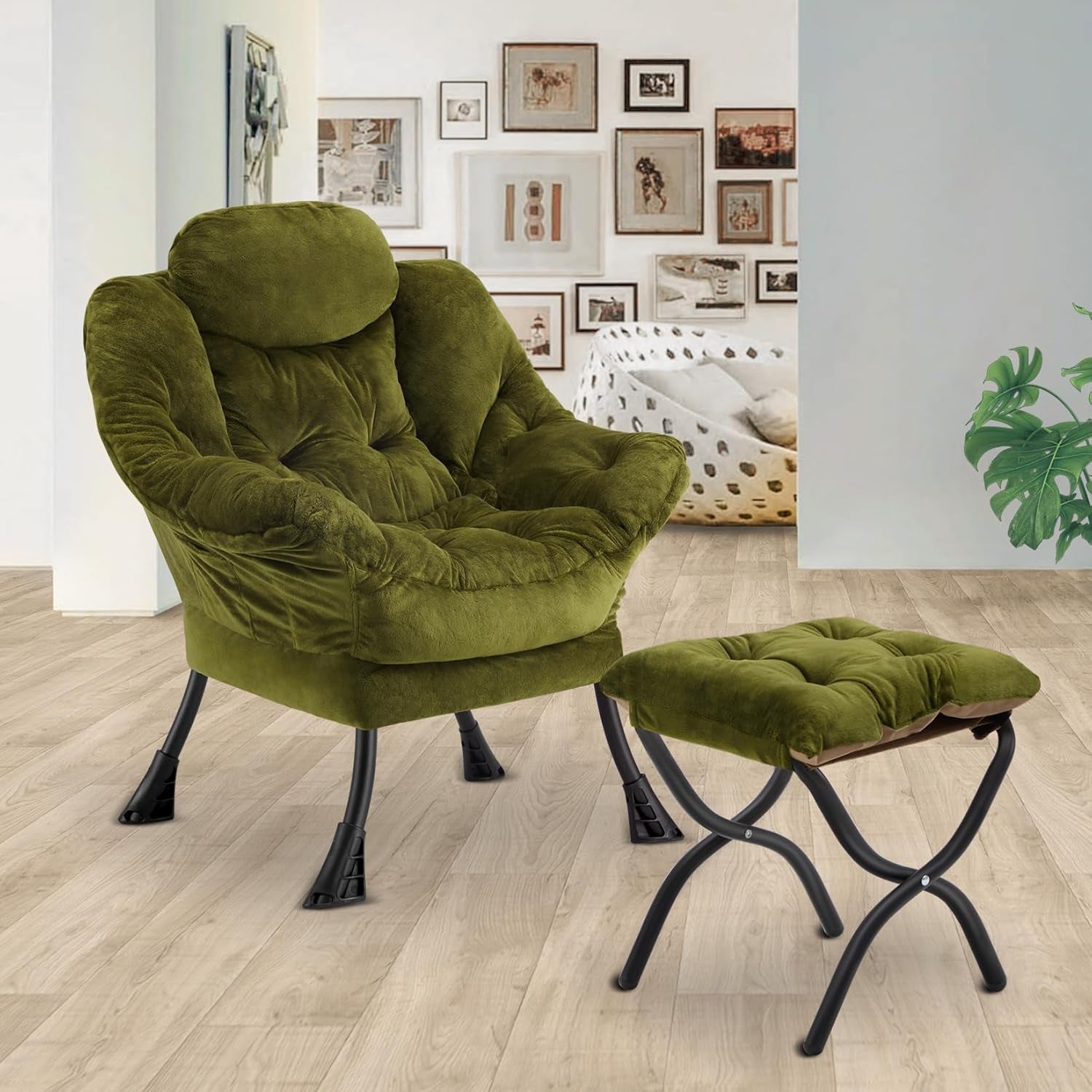 Green armchair with ottoman in a room with framed pictures on the wall.