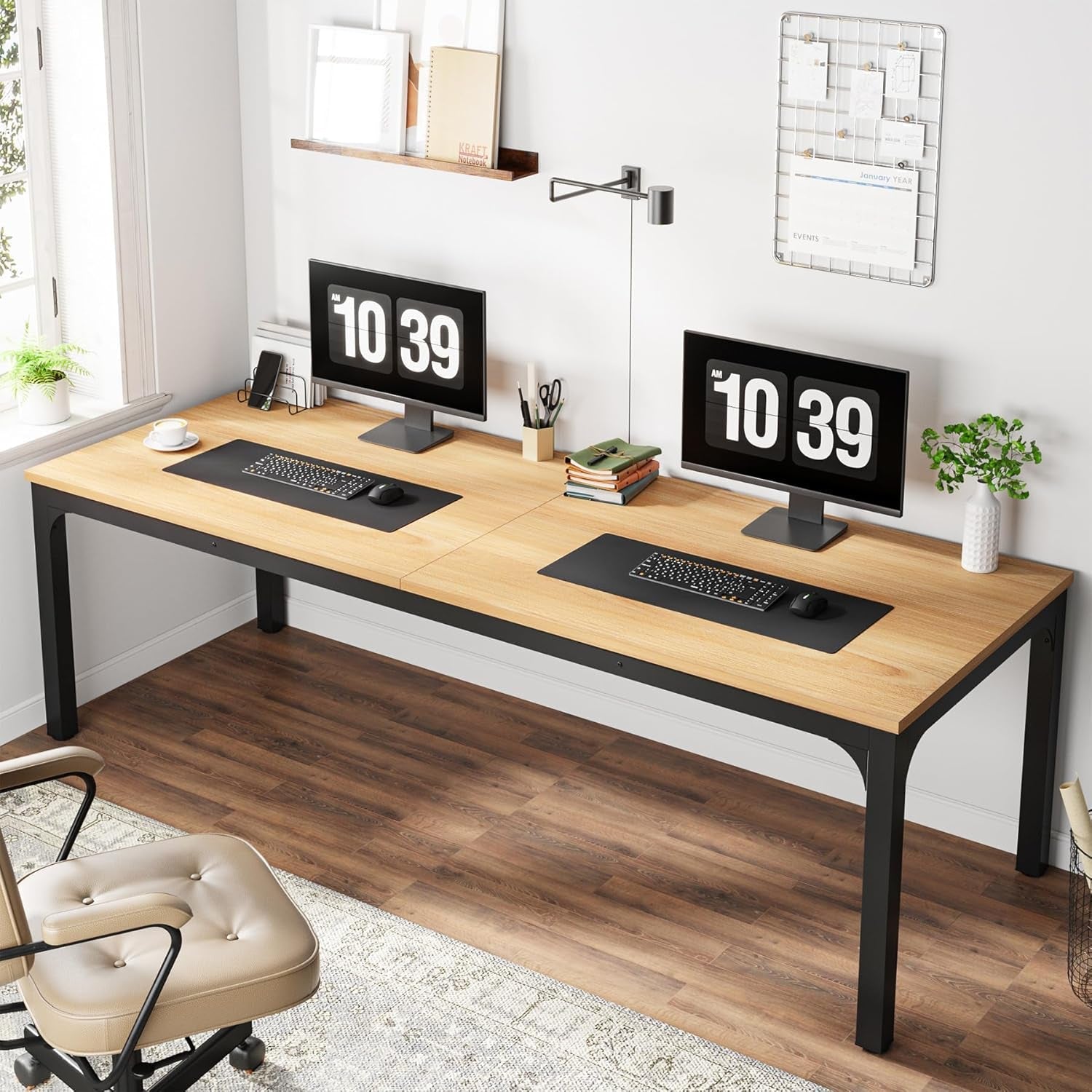 Wooden desk with two computer monitors, keyboard, and office supplies in a home office setting.