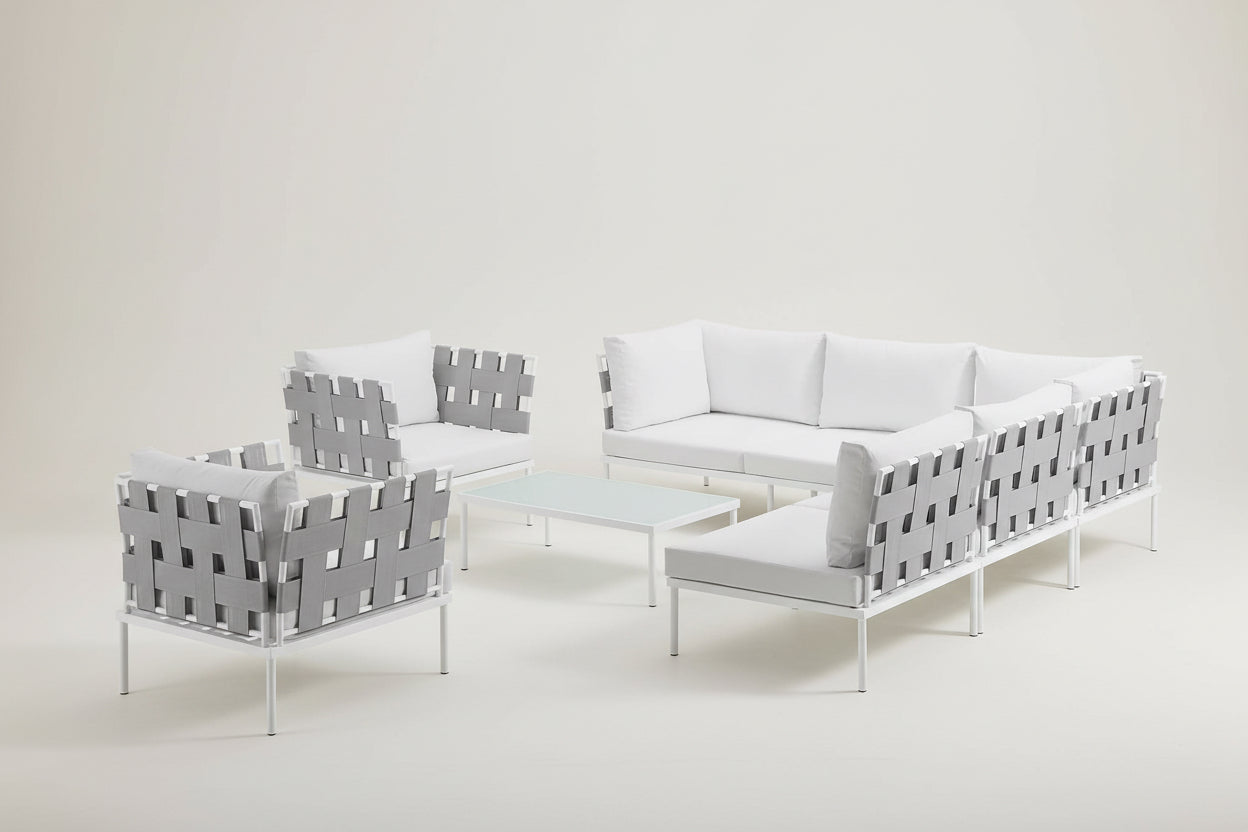 Outdoor furniture set with white cushions and gray metal frames on a white background