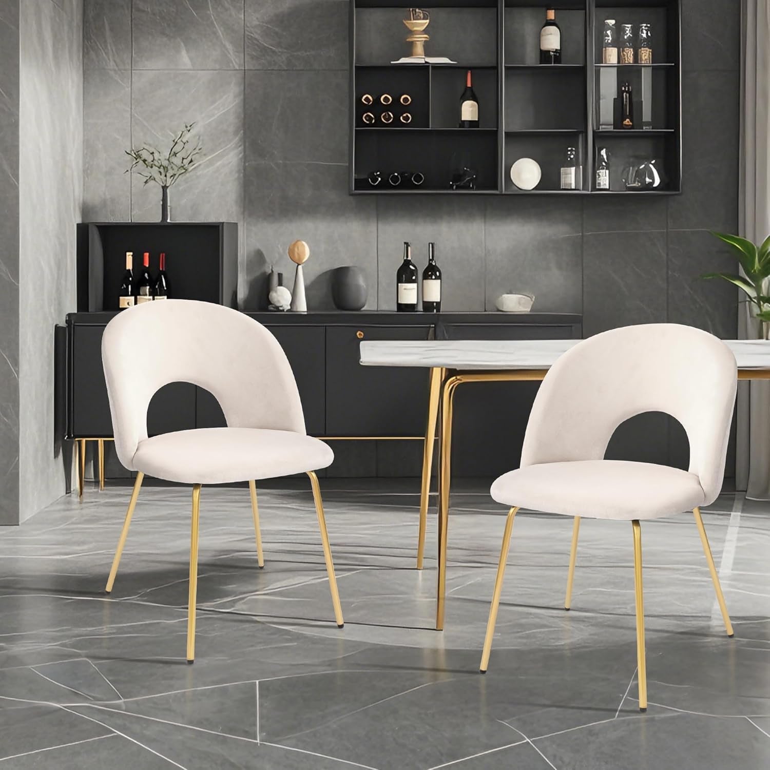 Two white chairs with gold legs in a modern interior setting.