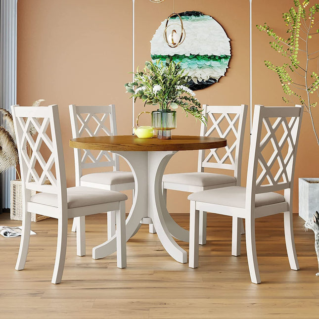 Dining room with a wooden table and white chairs against a beige wall.