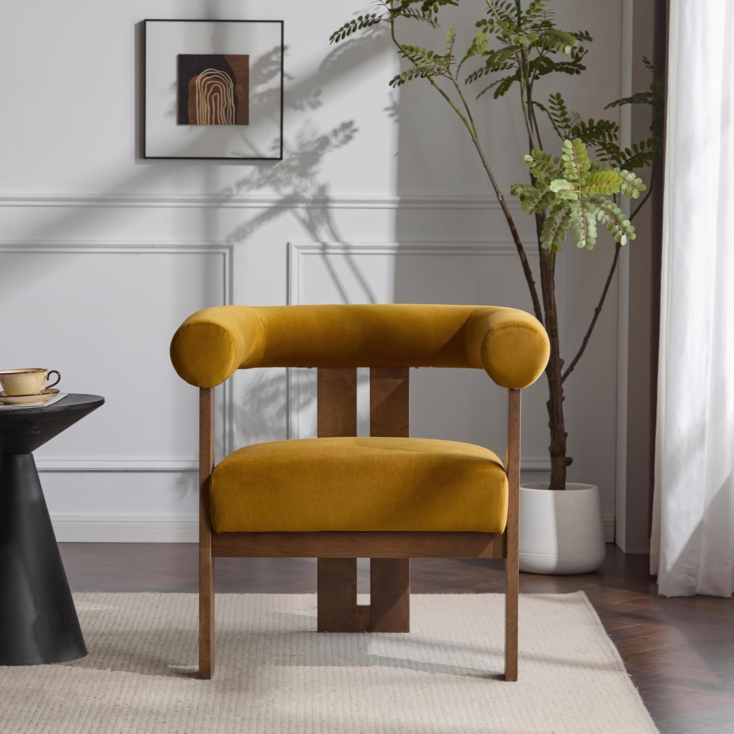 Mustard yellow armchair in a modern living room with a plant and side table.