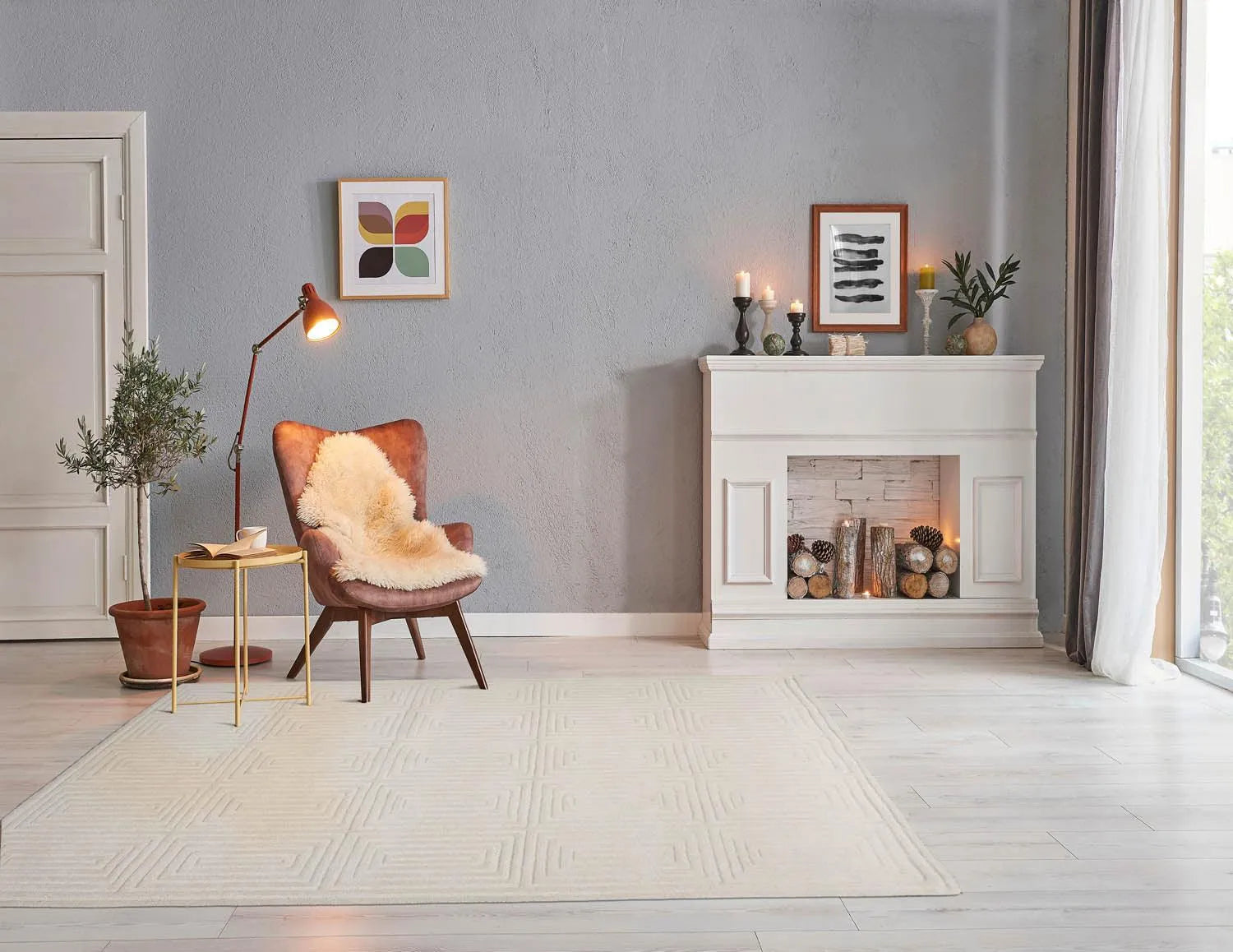 Modern living room with a fireplace, armchair, and decorative items.