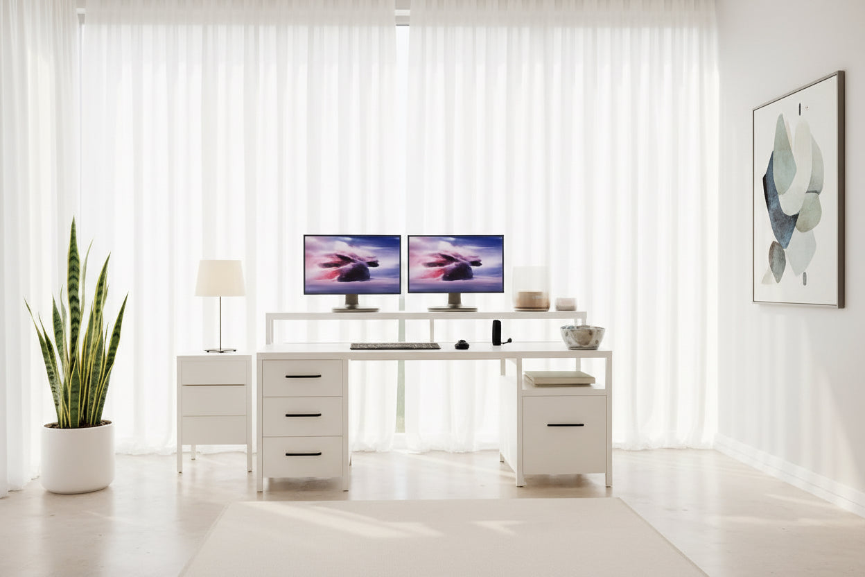 White office desk with two monitors, keyboard, and mouse in a room with beige walls and wooden floor.