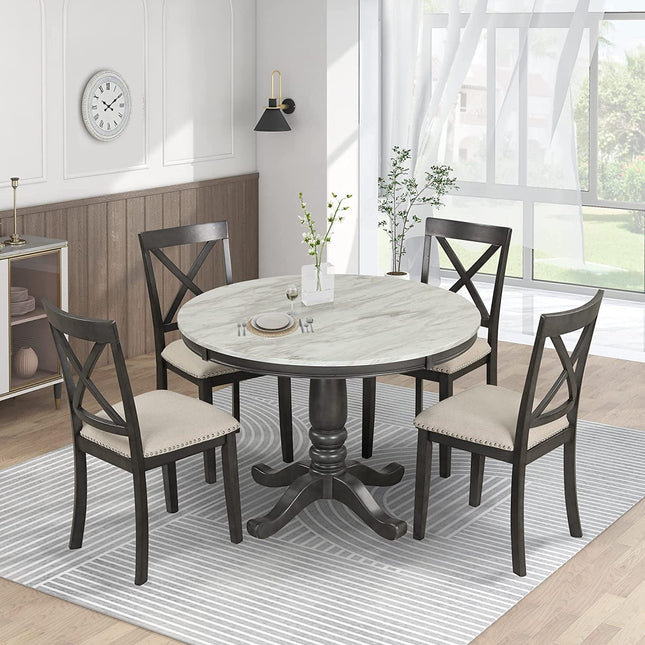 Dining room with a round table and four chairs in a well-lit room.