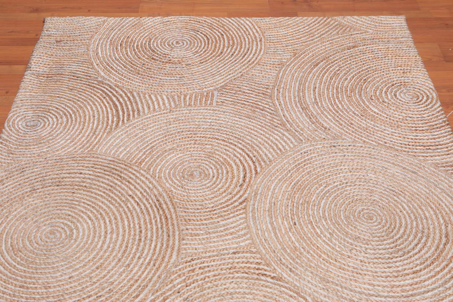 Textured area rug with circular patterns on a wooden floor