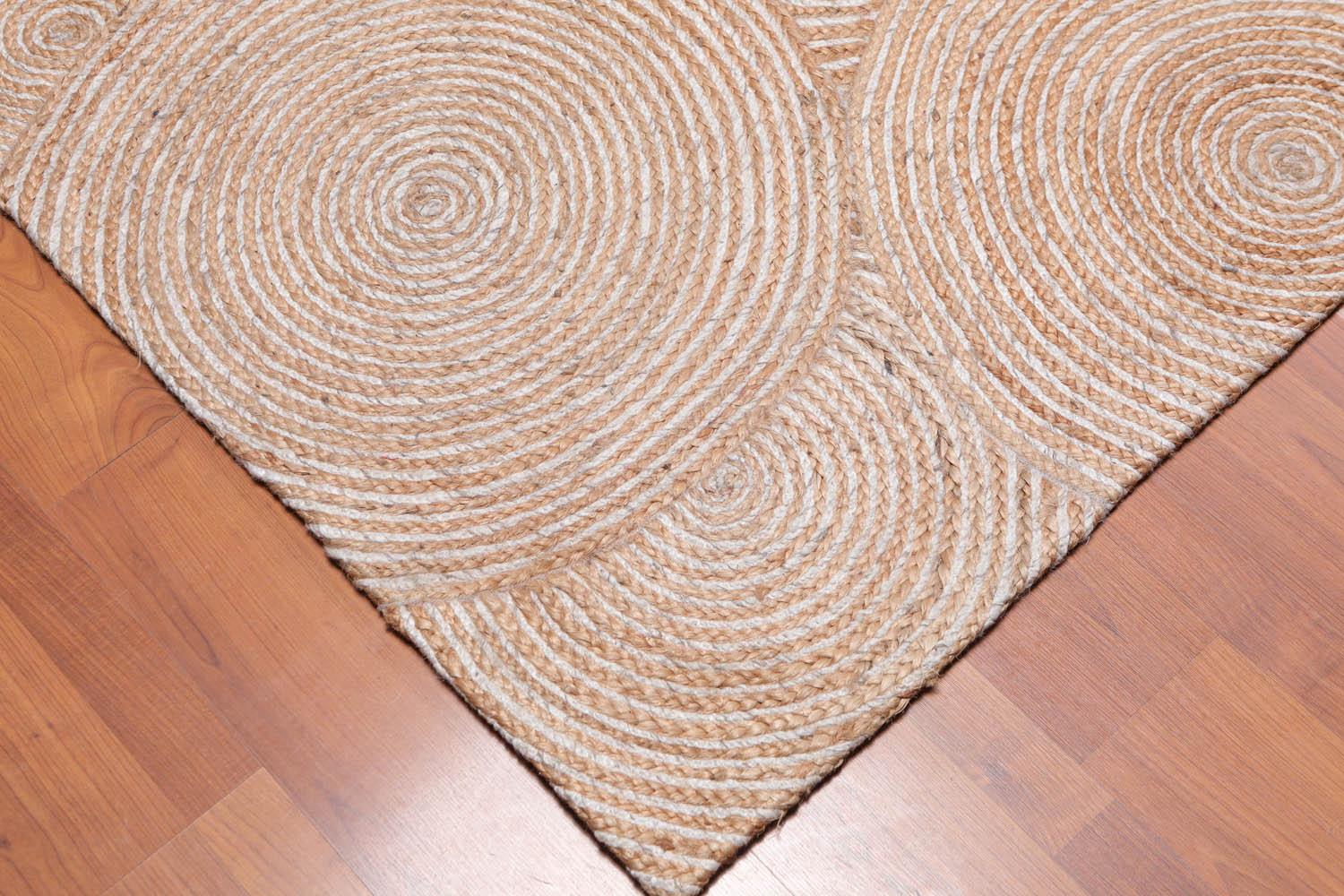 Beige woven rug on a wooden floor
