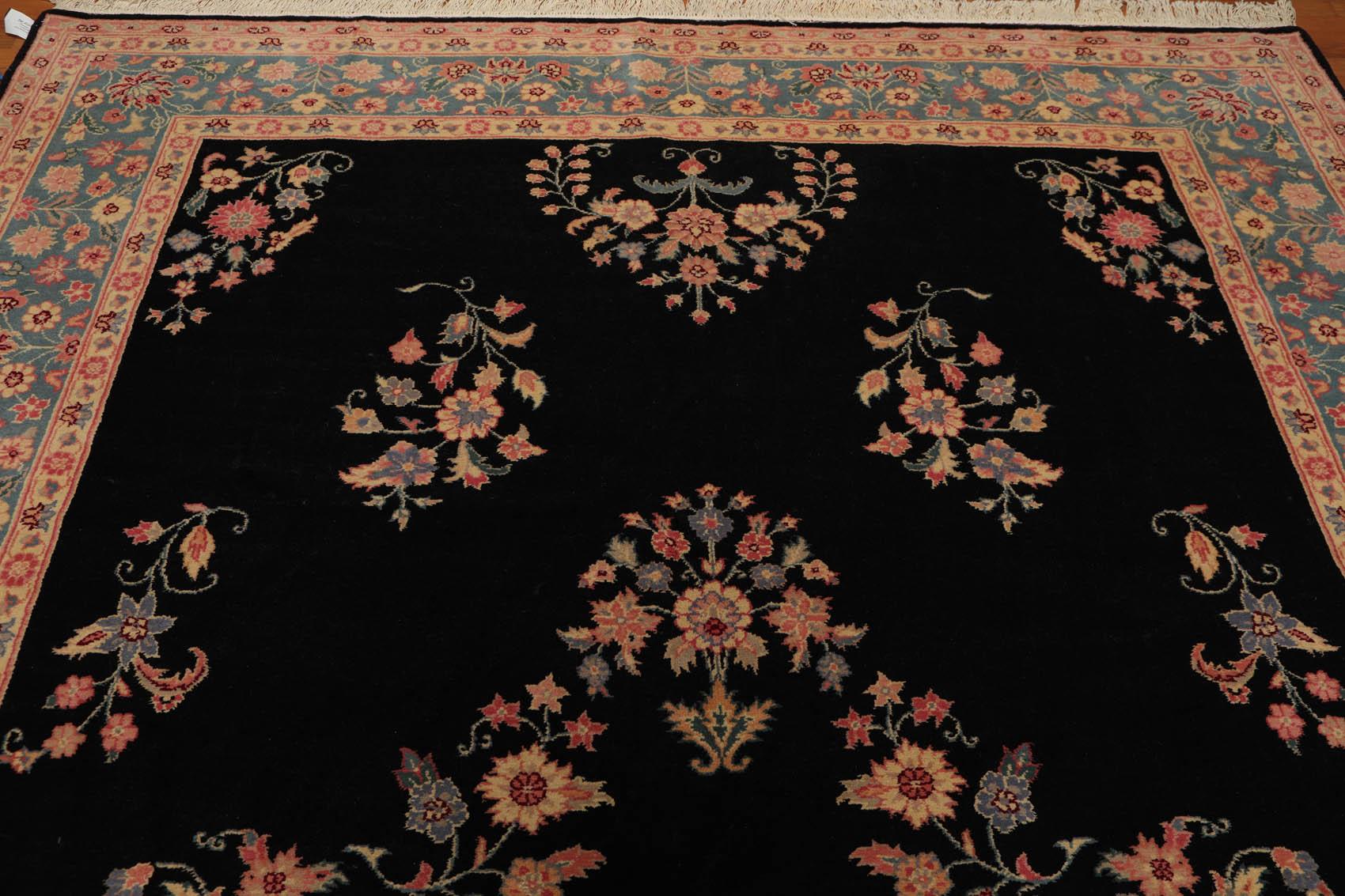 Decorative rug with intricate floral patterns on a black background