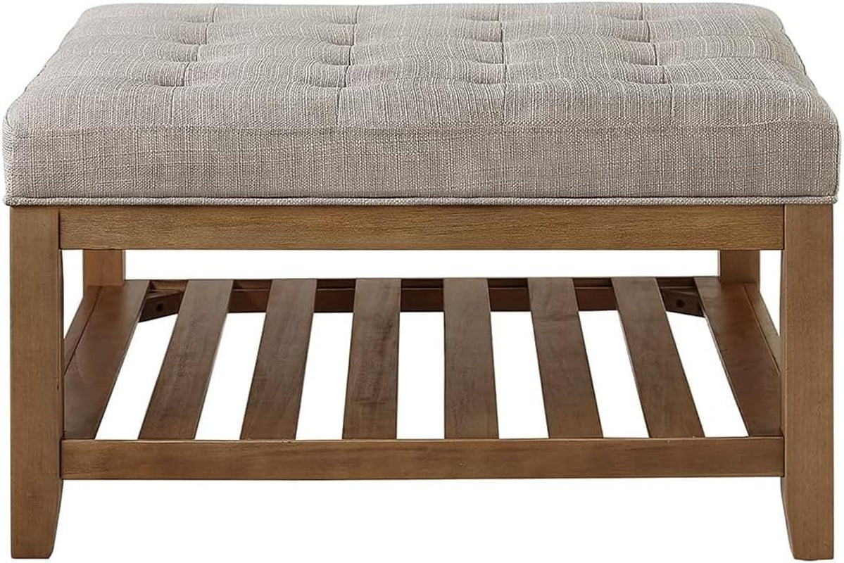 Wooden ottoman with a tufted gray cushion on a white background