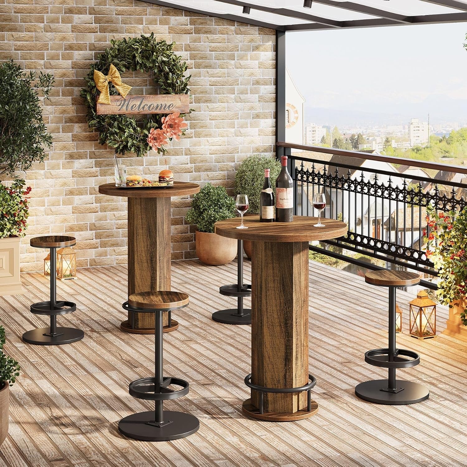 Outdoor patio setup with wooden bar tables and stools on a balcony.