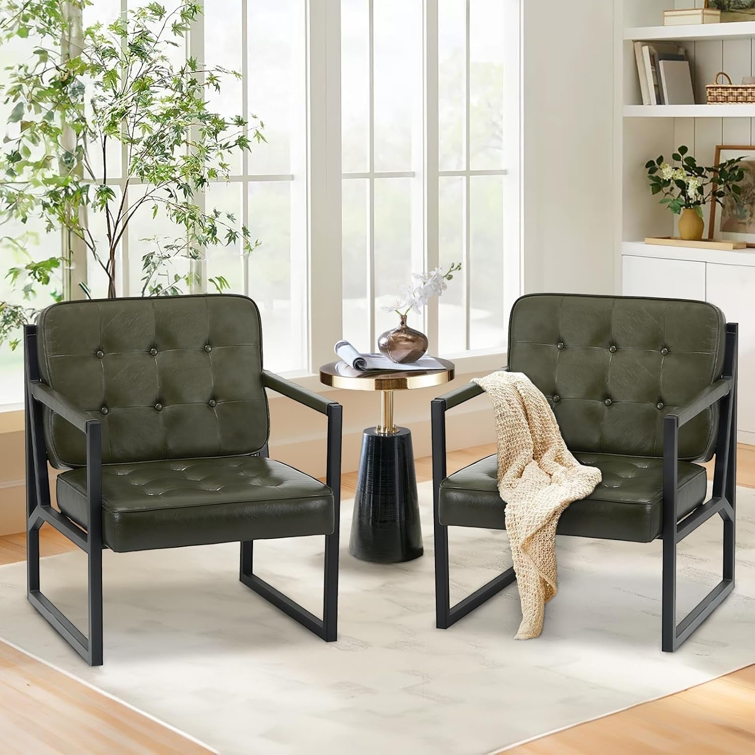 Two green chairs with black frames in a living room setting.