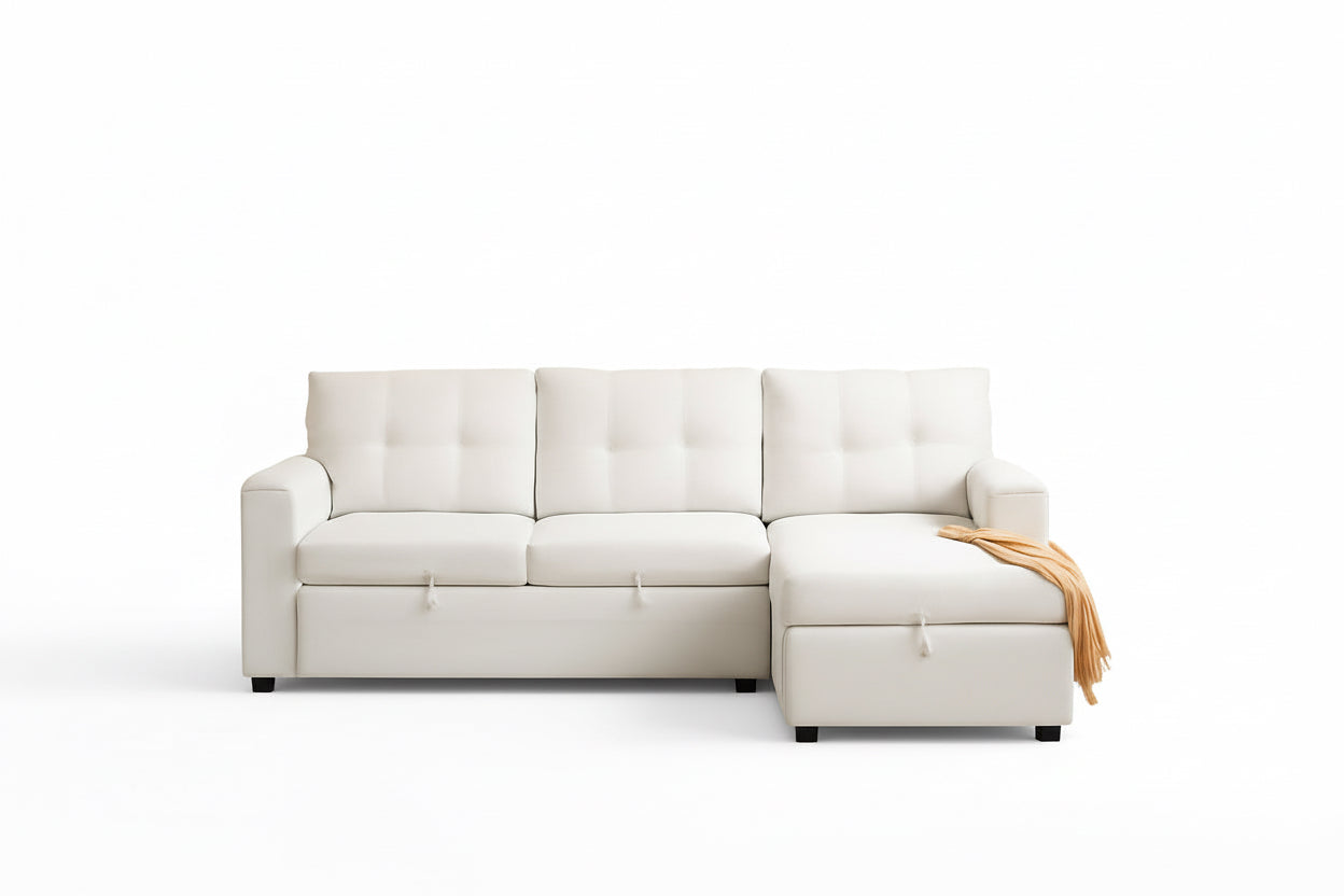 White sectional sofa in a room with beige walls and a small table with a vase.