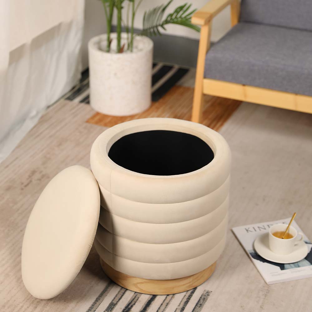 Beige storage ottoman with a black interior in a living room setting.