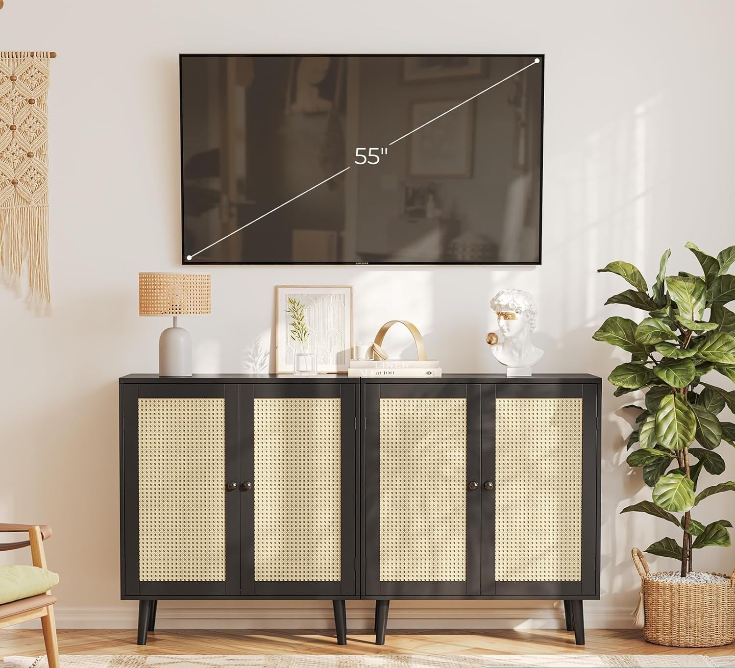 Living room with a TV mounted on the wall above a black cabinet with wicker doors.