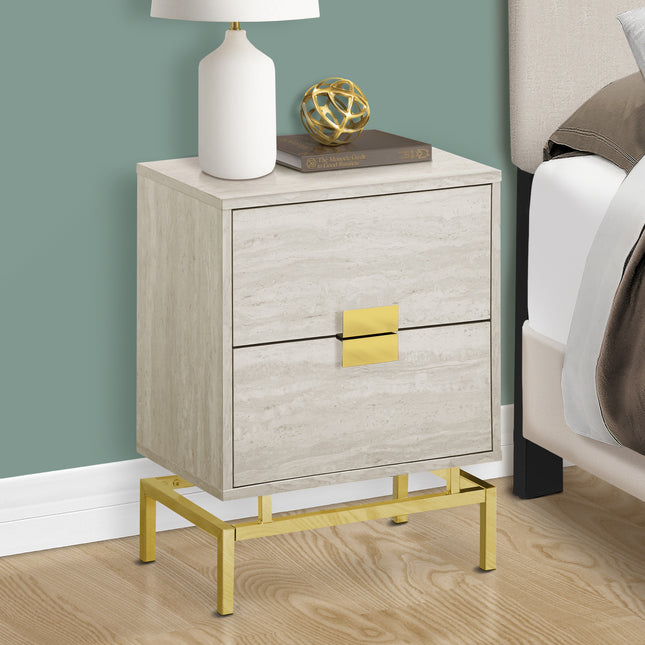 Beige nightstand with gold accents next to a bed with white and gray bedding.