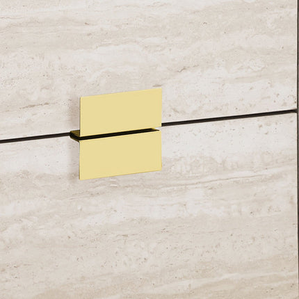 Gold square wall-mounted shower head on a beige tiled wall