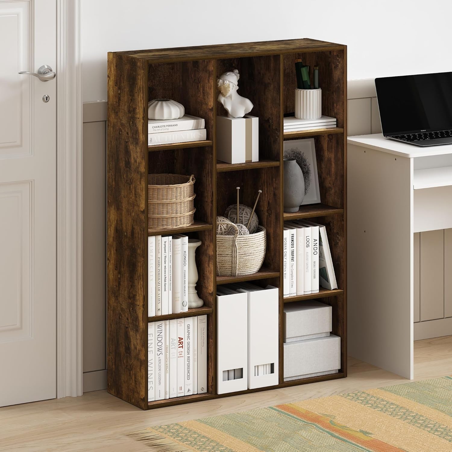 Wooden bookshelf with books and decorative items in a room with a desk and rug.