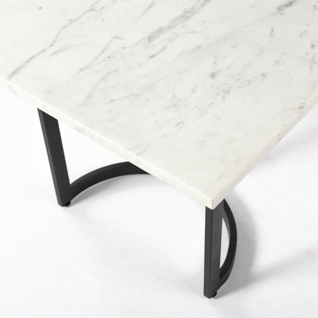 Marble-top table with black metal legs on a white background