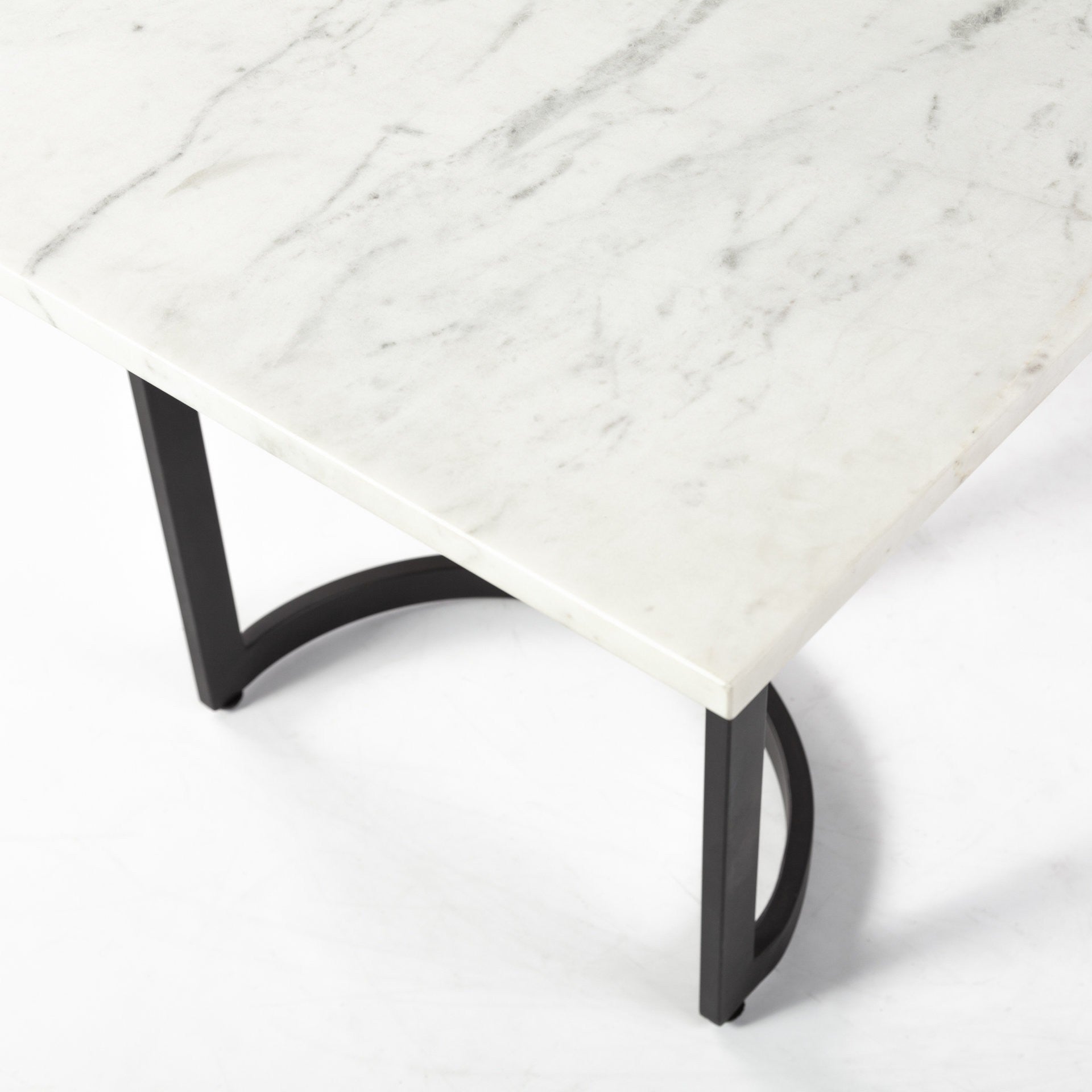 Marble-top table with black metal legs on a white background