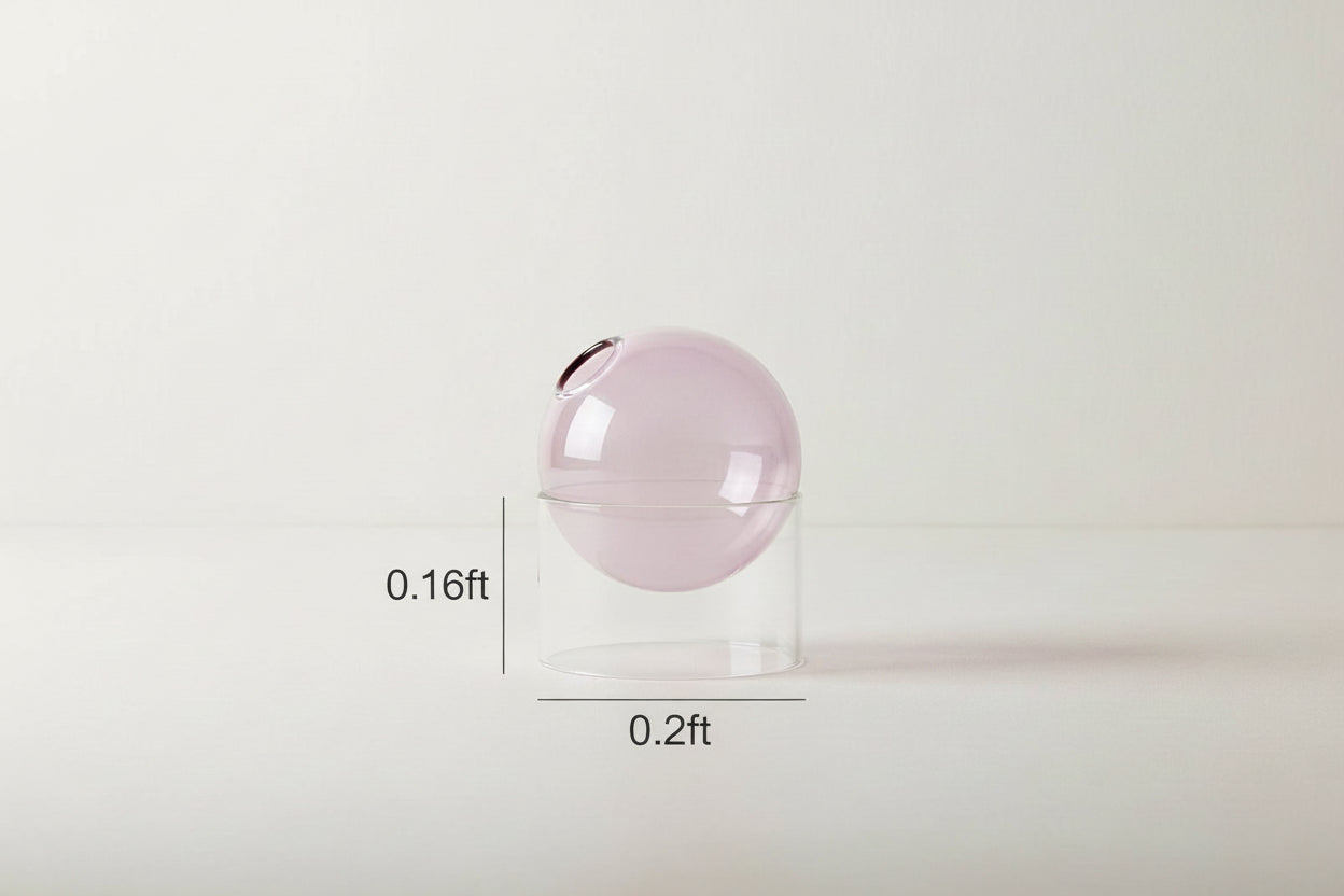 Transparent container with a spherical pink object inside, showing dimensions on a white background.