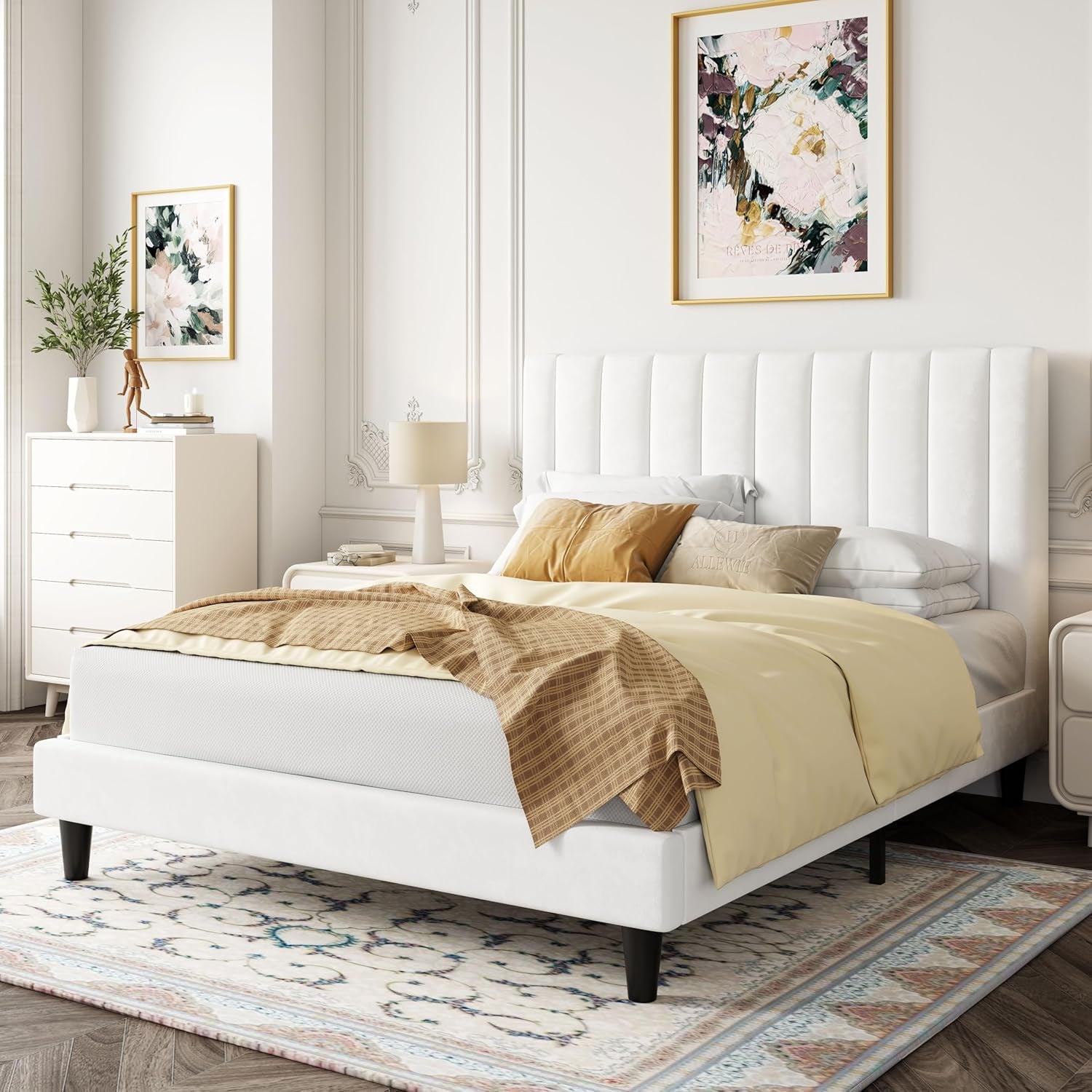 White upholstered bed in a bedroom with decorative elements.