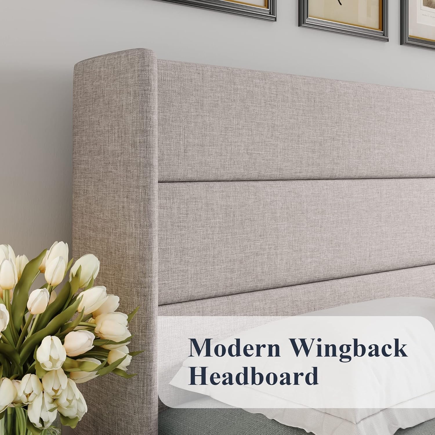 Gray wingback headboard with white tulips on a bed in a bedroom setting.