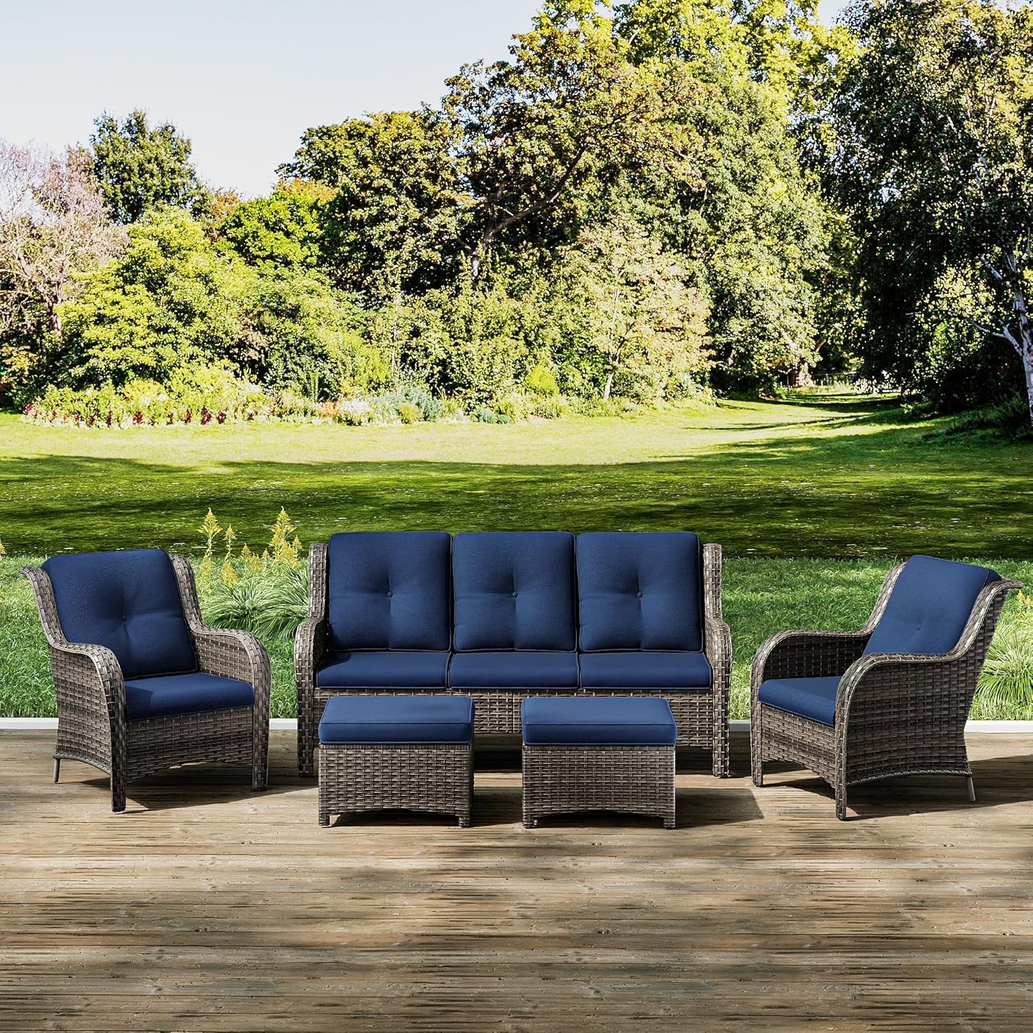 Outdoor patio furniture set with blue cushions on a wooden deck.