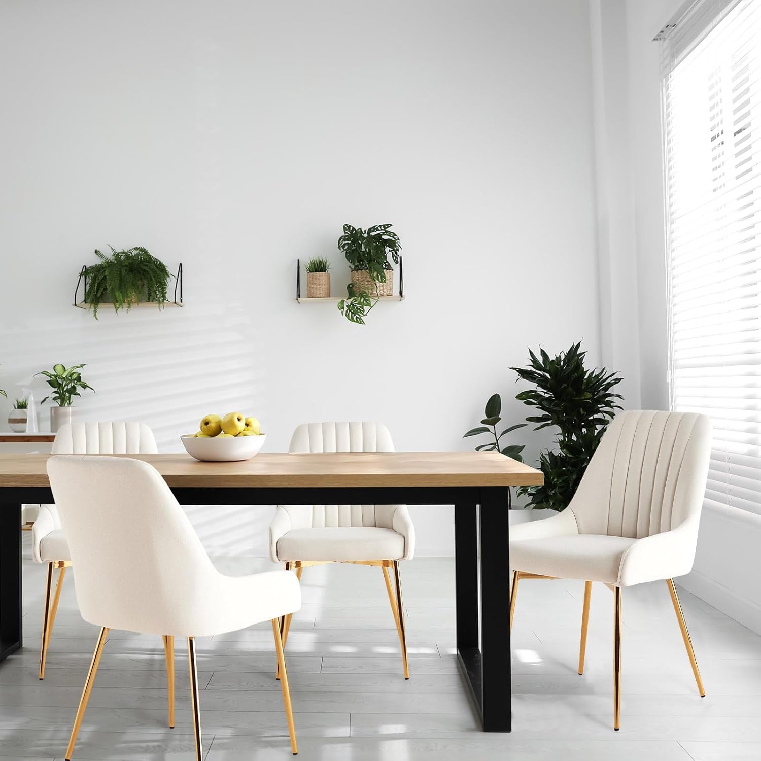 Modern dining room with a wooden table and white chairs, featuring decorative plants on the wall.