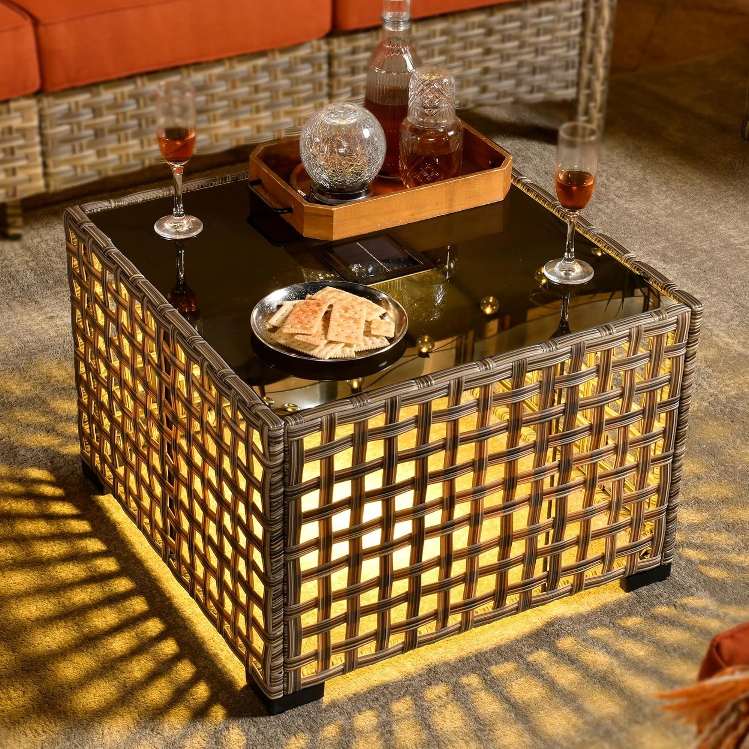 Decorative coffee table with a woven design, glassware, and snacks in a cozy indoor setting.