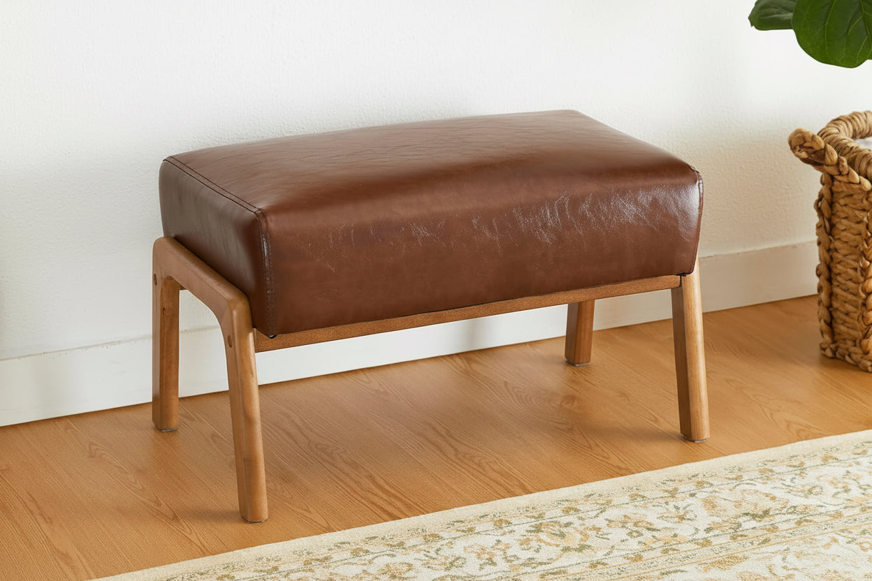 Brown leather ottoman with wooden legs on a wooden floor, surrounded by close-up details.