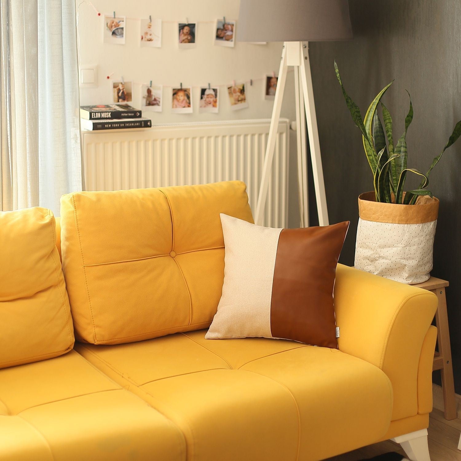 Yellow sofa with decorative pillows in a living room setting