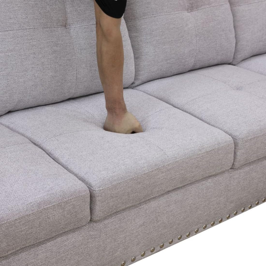 Gray sofa with a person's foot peeking out from under it