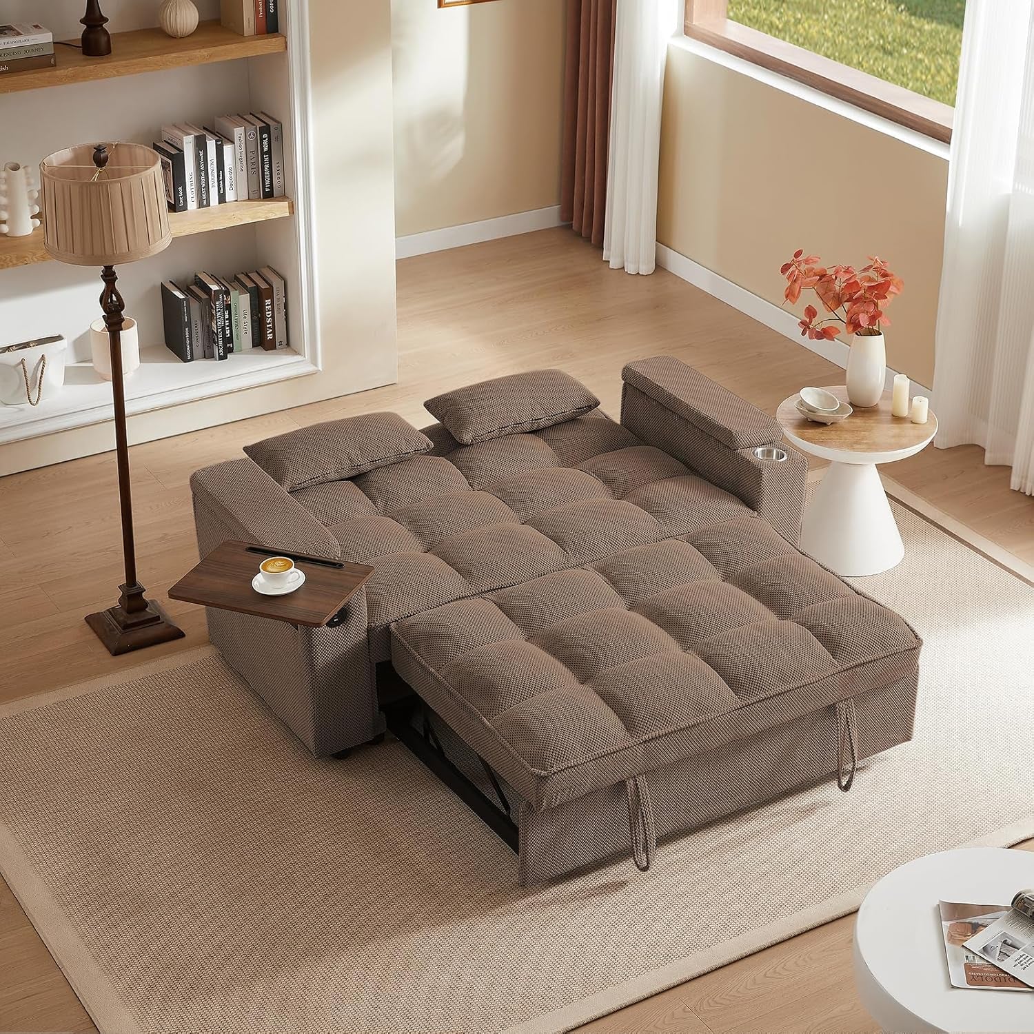 Gray sectional sofa in a living room setting with a bookshelf and small table.