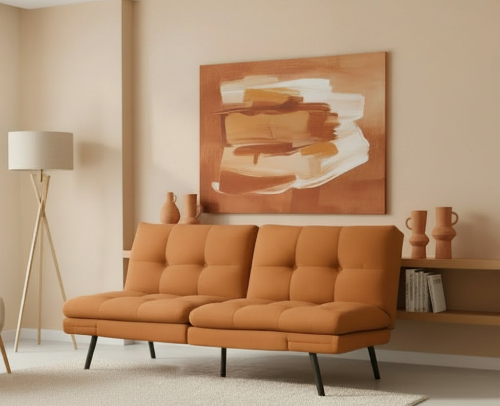 Orange sofa in a room with an orange wall and a side table with a lamp.