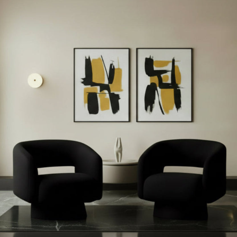 Two black chairs in a room with warm lighting.