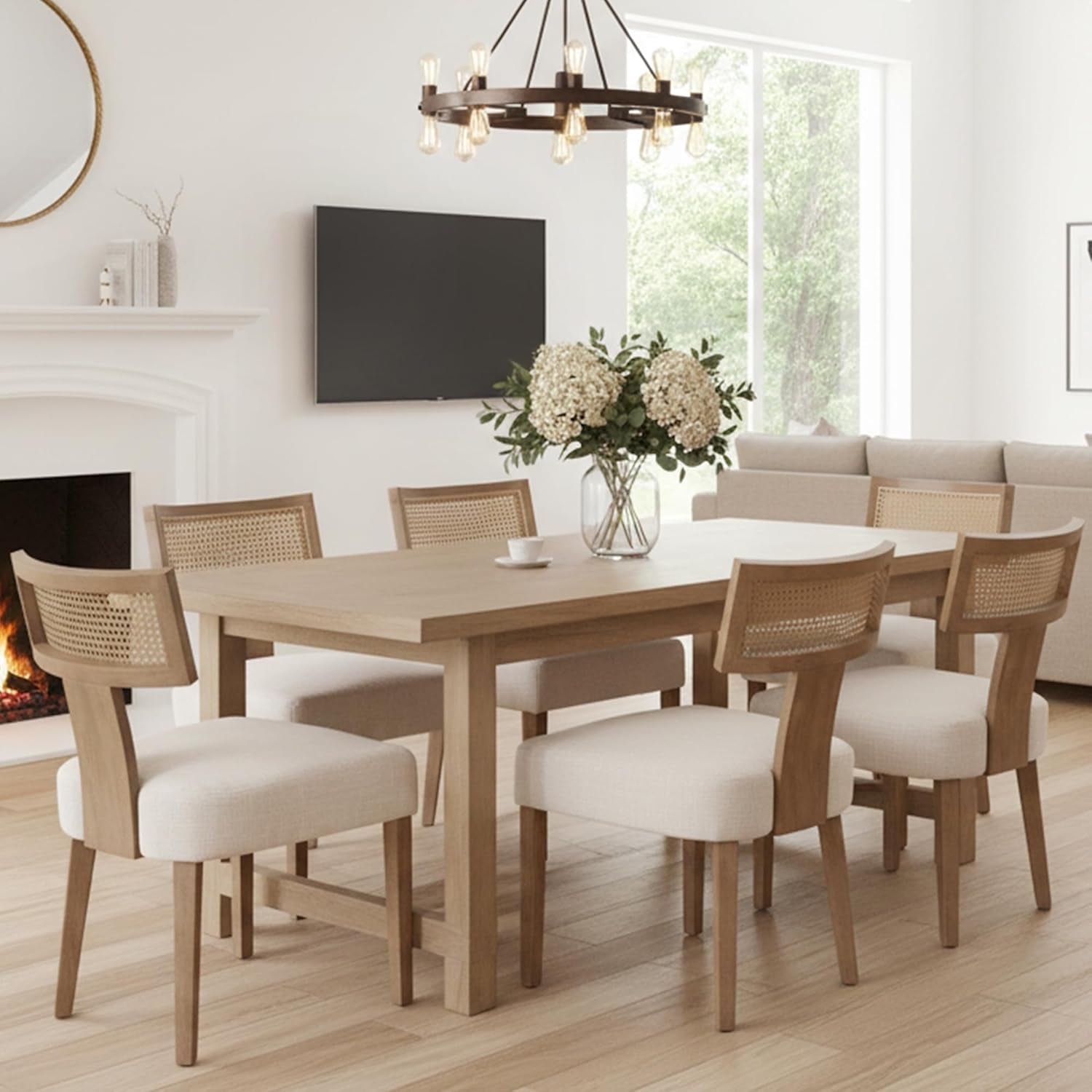 Dining room with wooden table and chairs, fireplace, and television.