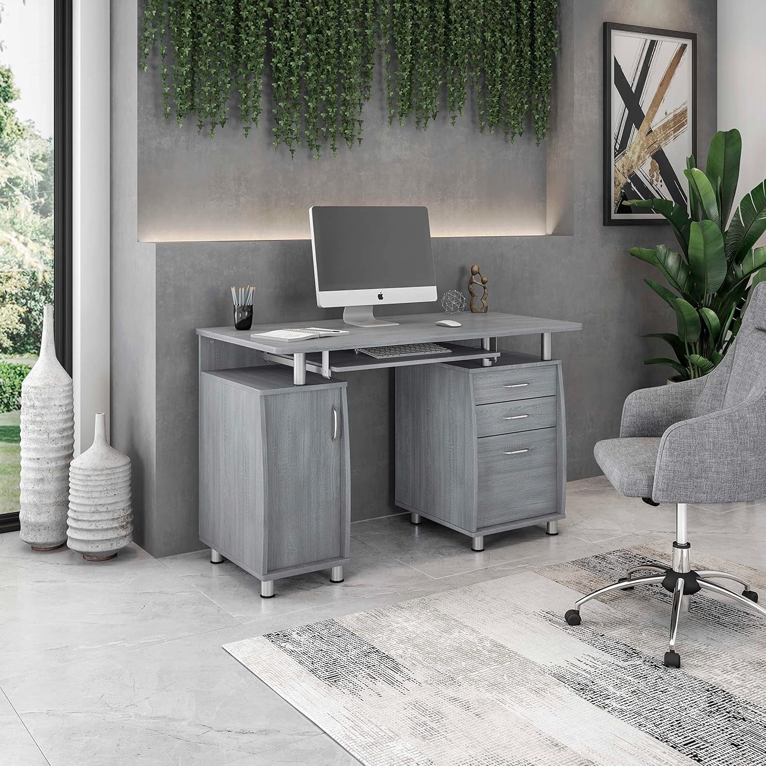 Modern office setup with a gray desk, chair, and decorative elements.