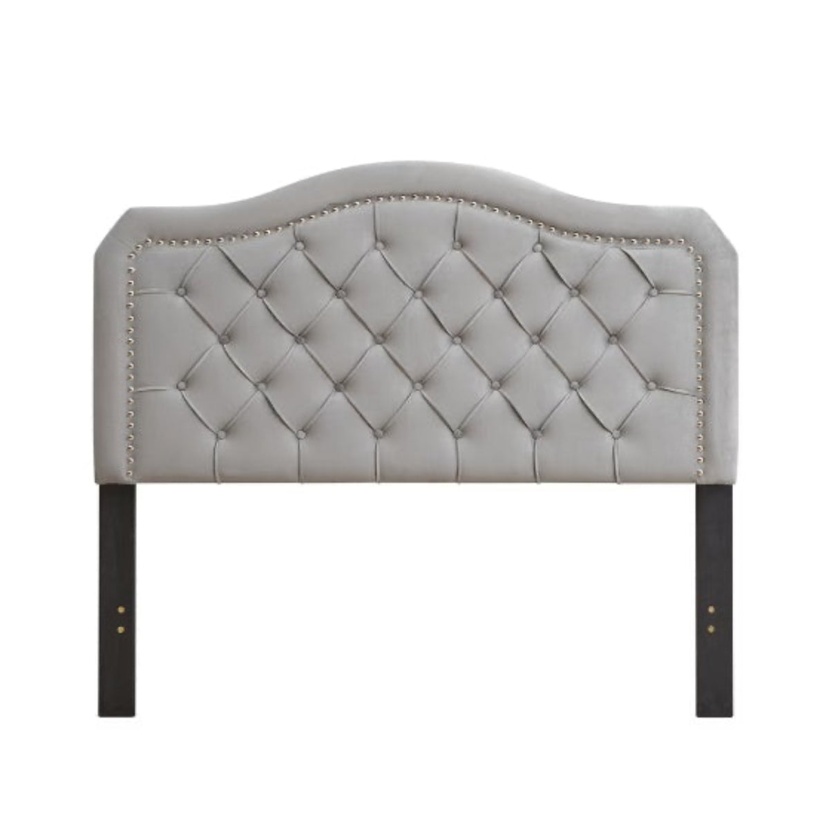 Gray tufted headboard with nailhead trim on a white background