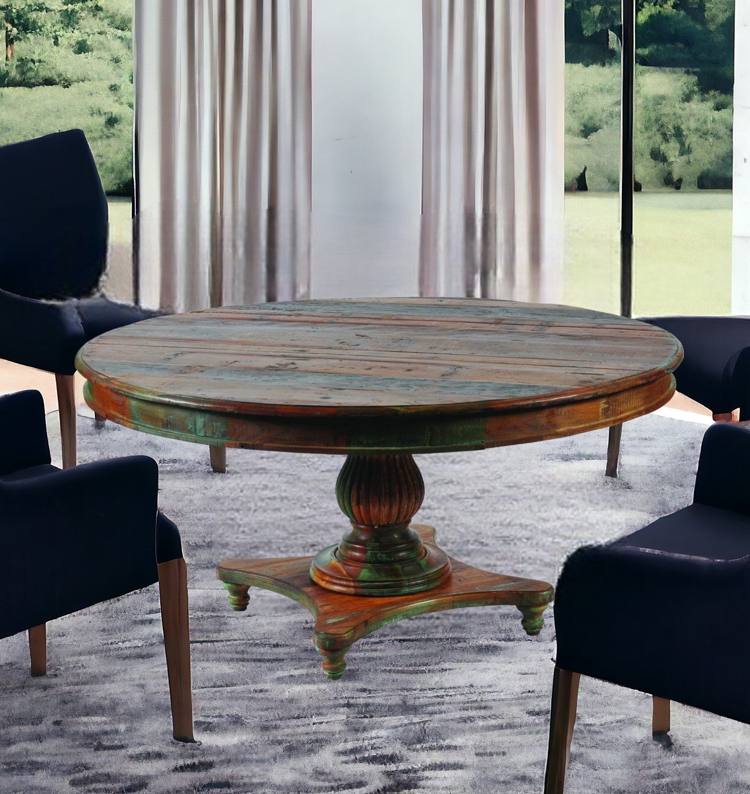 Round wooden table with a vintage design in a room with large windows and curtains.