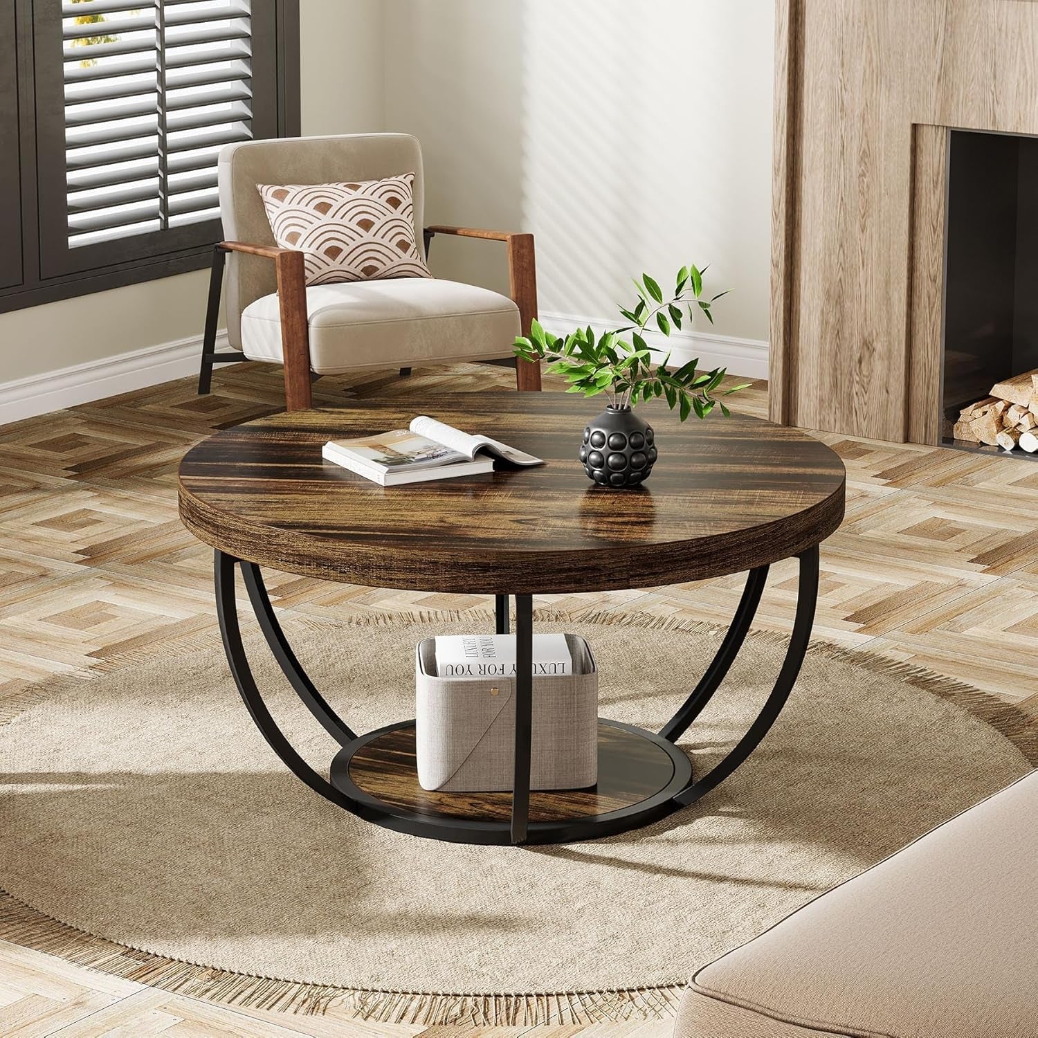 Round wooden coffee table in a living room with a chair and decorative items.